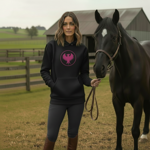 Woman in a black hoodie with a pink livid lava logo standing next to a horse in a field.